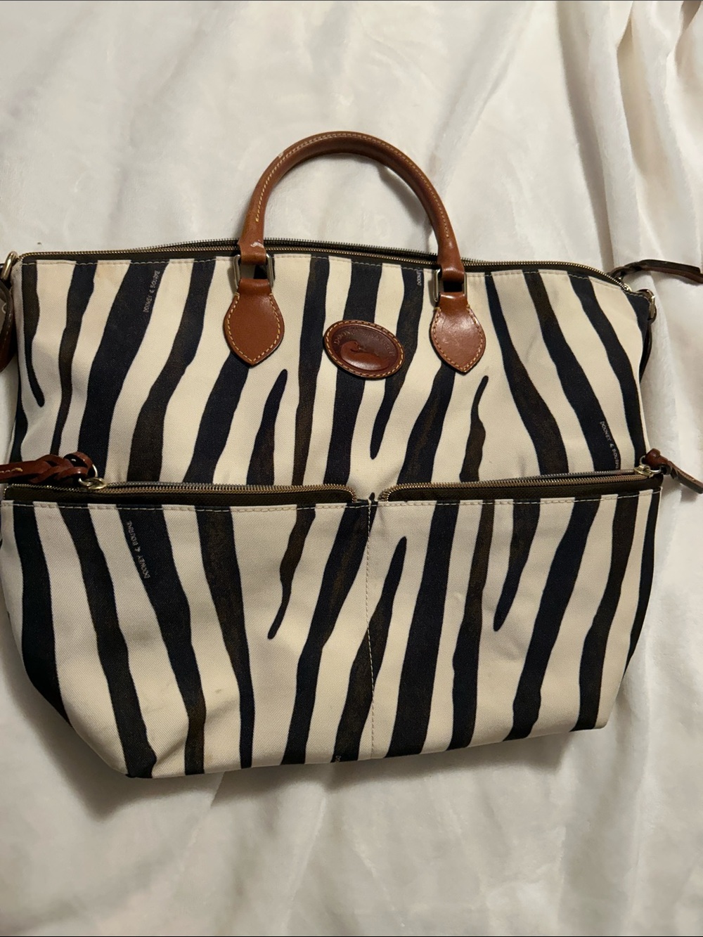 Dooney and Bourke Zebra print canvas Duffel with Brown Leather Trim